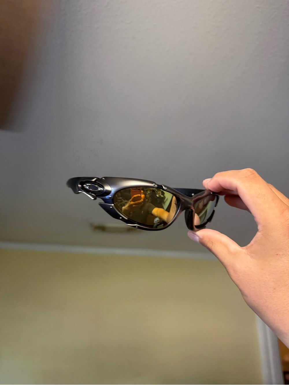 Oakley Black Frame Sunglasses with Gold Lenses